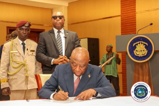 President Boakai signing