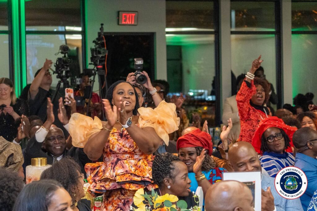 The audience applauding the President