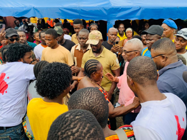 Cummings interacting with some residents of Point 4 on the Bushrod Island of Monrovia
