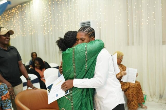 Former Vice President Jewel Howard Taylor hugs Grandson for academic achievement