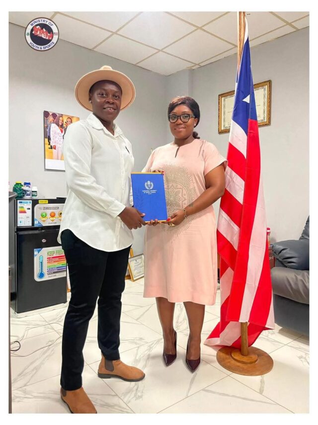 Coach Wellay T. Baar shares certificate with Youth and Sports Cornelia Kruah